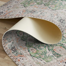 Load image into Gallery viewer, Close-up of a patterned rug with a curved beige object on top