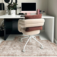 Load image into Gallery viewer, A modern beige upholstered swivel office chair with a white five-star base and casters, styled in a home office setting with a white desk, computer, and a textured brown PVC desk mat.