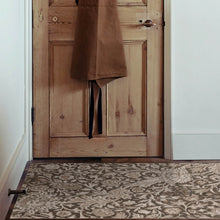 Load image into Gallery viewer, Brown coat hanging on a wooden door with a patterned rug on the floor.