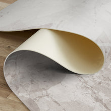 Load image into Gallery viewer, Close-up of a roll of gray and beige vinyl rug on a wooden surface.