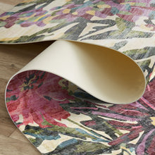 Load image into Gallery viewer, Roll of colorful patterned rug being unrolled on a wooden floor.