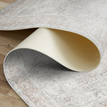 Load image into Gallery viewer, Close-up of a textured stone-like surface with a curved edge on a wooden floor.
