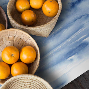 Assortment of oranges placed on vivid, blue and elegant placemat