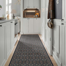 Load image into Gallery viewer, A long runner rug with an intricate traditional medallion pattern in navy, beige, and rust red, shown on a light wood floor in a bright, modern kitchen.
