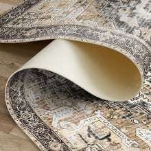 Load image into Gallery viewer, Close-up of a patterned rug with a white chair leg partially visible
