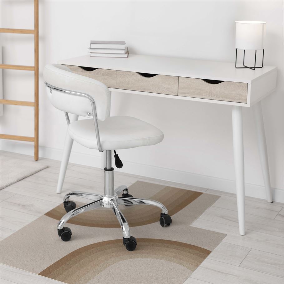 White office chair in front of a white desk with wooden accents on a light wood floor.