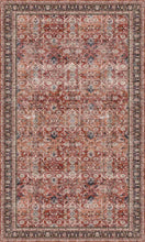 Load image into Gallery viewer, Patterned desl mat with a mix of red, brown, and beige colors on a dark background
