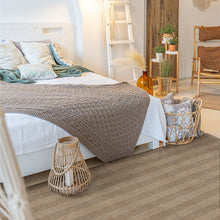 Load image into Gallery viewer, Bedroom with a bed, pillows, and a textured rug.
