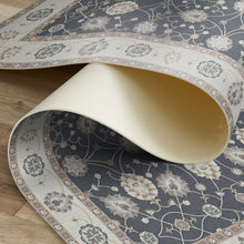 Load image into Gallery viewer, Roll of patterned rug on a wooden floor
