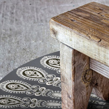 Load image into Gallery viewer, Dark grey pet friendly vinyl mat floor cloth inspired by mandala design nder a bench
