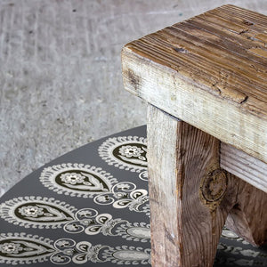 Dark grey pet friendly vinyl mat floor cloth inspired by mandala design nder a bench
