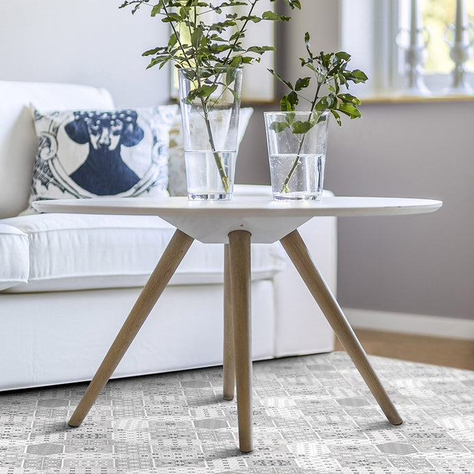 grey patchwork vinyl mat below a living room table