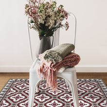Load image into Gallery viewer, bordeaux color vinyl mat design  inspired by Spanish floor tiles under a sitting chair
