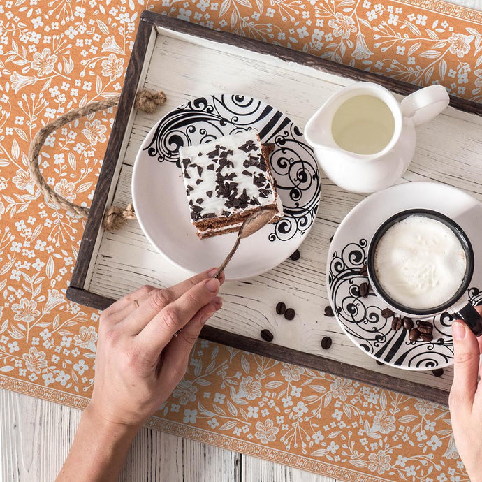 set of coffee cups on a orange colored placemat