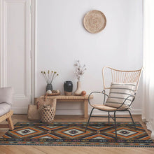 Load image into Gallery viewer, Orange vinyl mat Inspired by authenticate ethnic rugs in a small living room
