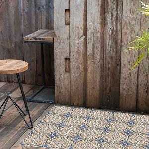 Beige and blue vinyl mat with Spanish tile design in a rustic wooden room