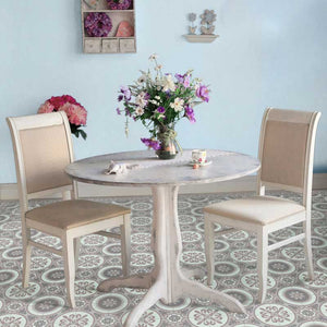 Grey vintage vinyl floor mat with Spanish tile designs in a small rounded dining table